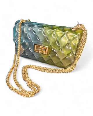 A fashionable quilted jelly crossbody bag in an ombre design of green and blue shades with a gold chain strap and clasp.