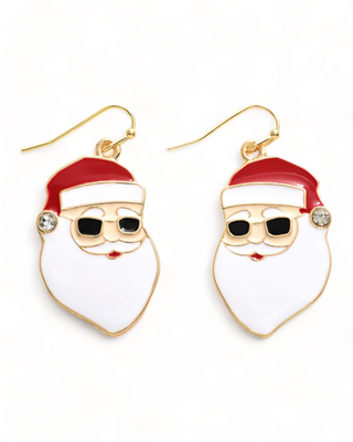 Dangling earrings depicting a stylized Santa Claus face with sunglasses and a red hat, complete with a sparkling gemstone at the hat tip.