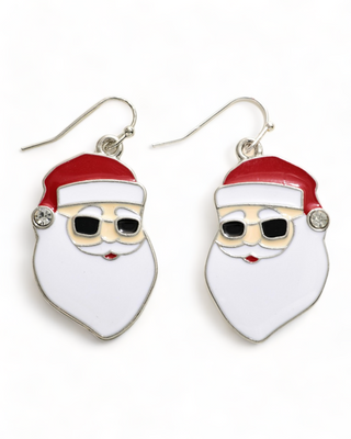 Dangling earrings depicting a stylized Santa Claus face with sunglasses and a red hat, complete with a sparkling gemstone at the hat tip.