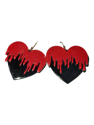 Dangling earrings in the shape of hearts, designed with a top layer of red over a black base to simulate dripping blood, creating a dramatic effect