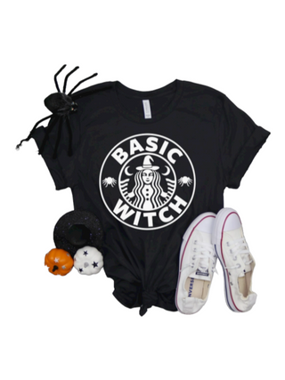 Black T-shirt featuring a white graphic with the phrase 'Basic Witch' and a witch design in a circle reminiscent of a well-known coffee shop logo.