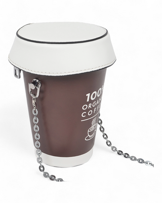 A coffee cup-shaped crossbody bag with a brown base and "100% Organic Coffee" text, a white lid design, and a silver metallic chain strap.