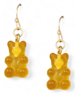 A pair of orange gummy bear earrings with gold hooks.