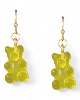 A pair of yellow gummy bear earrings with gold hooks.