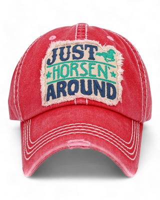 distressed baseball cap featuring an embroidered patch with the text "Just Horsen' Around" and a playful horse graphic,