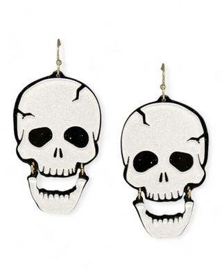 A pair of striking skull earrings with a sparkling white finish and a dangling jaw