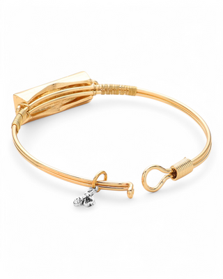 Gold-tone wire bangle bracelet with a rectangular plate featuring "Nurse" script, a nurse hat, and heart details, plus a dangling stethoscope charm.