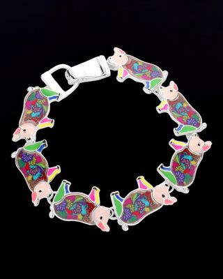 Silver bracelet featuring multiple colorful pig charms with intricate floral patterns and bright accents