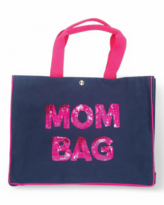 A large tote bag with "MOM BAG" in sparkling pink sequins, featuring sturdy handles and contrast piping for a fun and functional everyday carry.