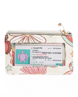 A compact zippered wallet with a clear ID window, decorative pattern, and a secure zip closure, designed for convenience and style.