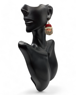 A sparkling Santa dangle earring displayed on a black mannequin bust. The earring features a jolly Santa face with a red rhinestone hat and a glittering beard, creating a festive and playful holiday look.