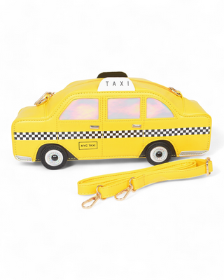 A yellow crossbody bag designed as a miniature NYC taxi cab, featuring checkered detailing, holographic window accents, and a detachable yellow strap with gold hardware.