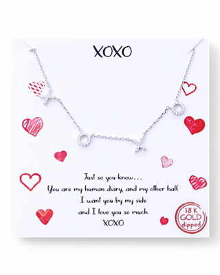 XOXO necklace with crystal accents on a delicate chain, displayed on a heartfelt message card