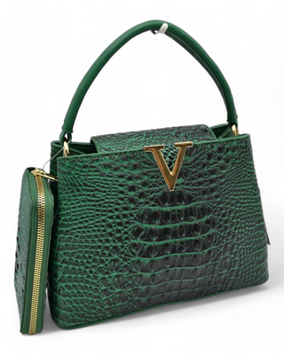 A textured handbag with a gold "V" detail on the front, featuring a top handle and an optional shoulder strap. The bag comes with a matching wallet and has a sleek, structured design.