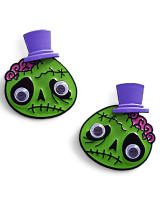 Googly-eyed green zombie earrings with a purple top hat and exposed pink brain detail