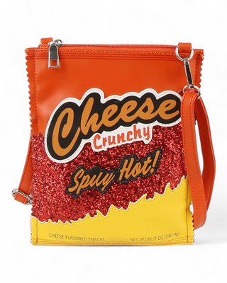 A crossbody bag designed to look like a snack package with "Cheese Crunchy Spicy Hot!" text, featuring vibrant orange and yellow colors with red glitter accents.