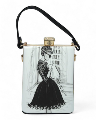 A stylish handbag featuring a black and white illustration of a woman in a classic black dress, with a structured design and black strap.