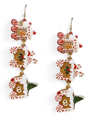 Dangle earrings featuring gingerbread train cars with red and white peppermint wheels, festive icing, and holly decorations.