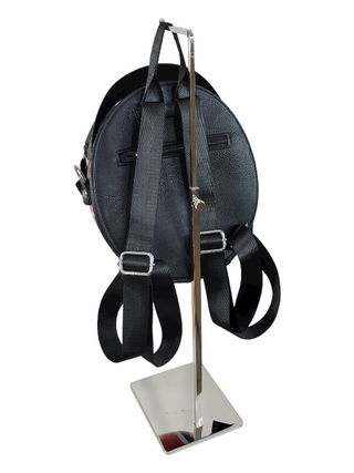 Back of motorcycle helmet shaped backpack hanging from a stand