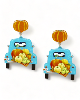 A pair of pumpkin truck earrings featuring a retro blue truck loaded with pumpkins and a pumpkin stud at the top.