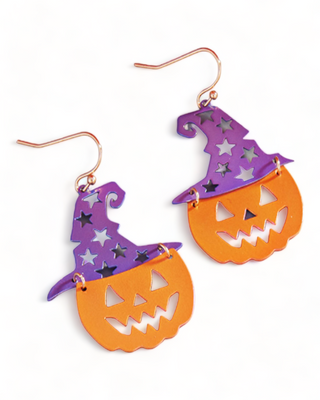 earrings featuring a combination of a pumpkin and a witch hat. The pumpkin is in a bright orange color with a carved face, while the hat is in purple with star cut-outs.